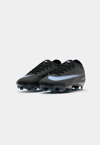 Black soccer cleats made of textured material with a light blue swoosh, featuring pointed studs and a streamlined design for performance.