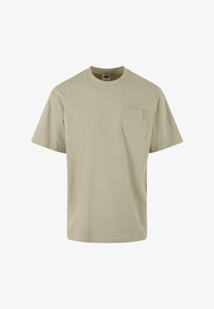 T-shirt beige a maniche corte realizzato in cotone, con colletto rotondo e taschino sul lato sinistro del petto. Colore uniforme con una texture morbida.