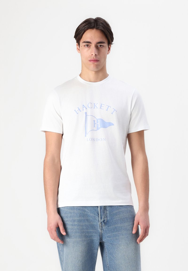 White cotton t-shirt featuring a blue printed logo with a flag design and the text "HACKETT LONDON." Short sleeves and round neck.