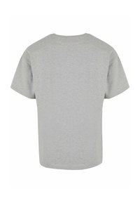 Camiseta gris de manga corta con cuello redondo y un corte relajado. Fabricada en un tejido suave y texturizado de un color uniforme.