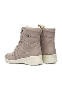 Botines de ante gris claro con forro textil, que cuentan con correas diagonales y cremallera lateral. Suela de goma texturizada para tracción.