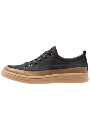 Niskie skórzane sneakersy z czarną cholewką, brązową środkową częścią, beżową podeszwą i czarnymi sznurowadłami, widziane z boku na białym tle.