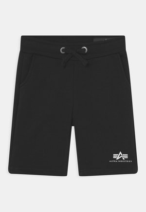 Schwarze Shorts aus weichem Stoff, mit einem elastischen Bund und Kordelzug, zwei Seitentaschen und einem weißen Logo am unteren Bein.