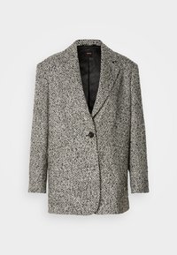 Tekstureeritud must-valge houndstooth bleiser, millel on nurgaalused klapid, üks must nupp ja tikitud must vooder. Pikad varrukad, mugav lõige.