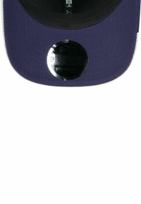 Granatowa czapka z lekko zakrzywionym daszkiem, czarnym spodem i okrągłą metką z detalami "9FIFTY" i "STRETCH-SNAP". Gładka faktura materiału.