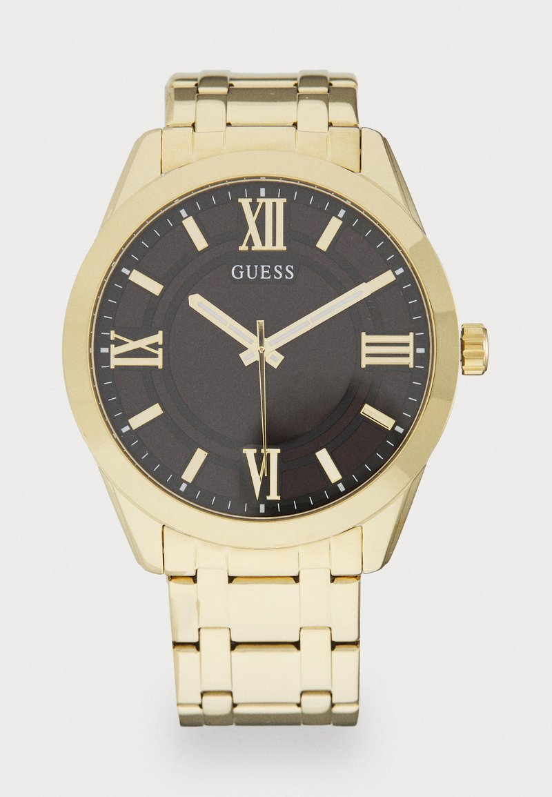Montre métallique dorée avec un cadran noir, des index en chiffres romains et trois aiguilles ; dotée d'un bracelet à maillons et d'un cadran marqué du logo.