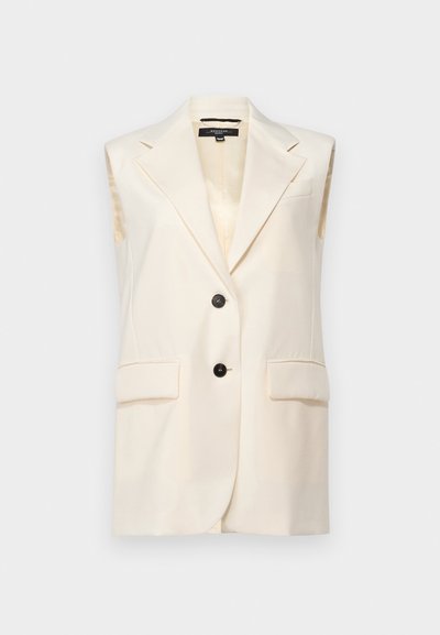 Hihaton kerma blazer, jossa on viistekaulus, kaksi etutaskua ja kaksinkertaiset mustat napit. Silkkinen tekstuuri ja jämäkkä istuvuus.