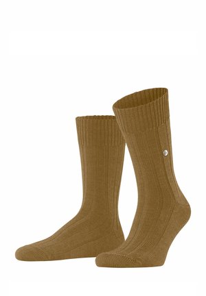 Braune, gerippte Socken mit einer gestrickten Textur, die über einen angepasst sitzenden Bund und einen kleinen Metallelement an der Seite verfügen.