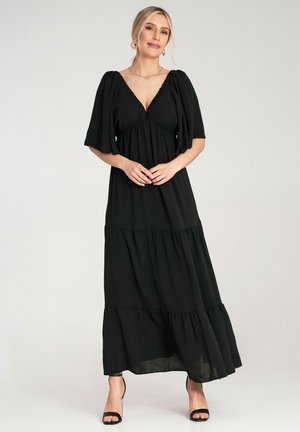 Schwarzes Maxikleid mit tiefem V-Ausschnitt, kurzen Puffärmeln und gestufter Rüschendesign. Aus leichtem Stoff, der eine lockere Passform bietet.