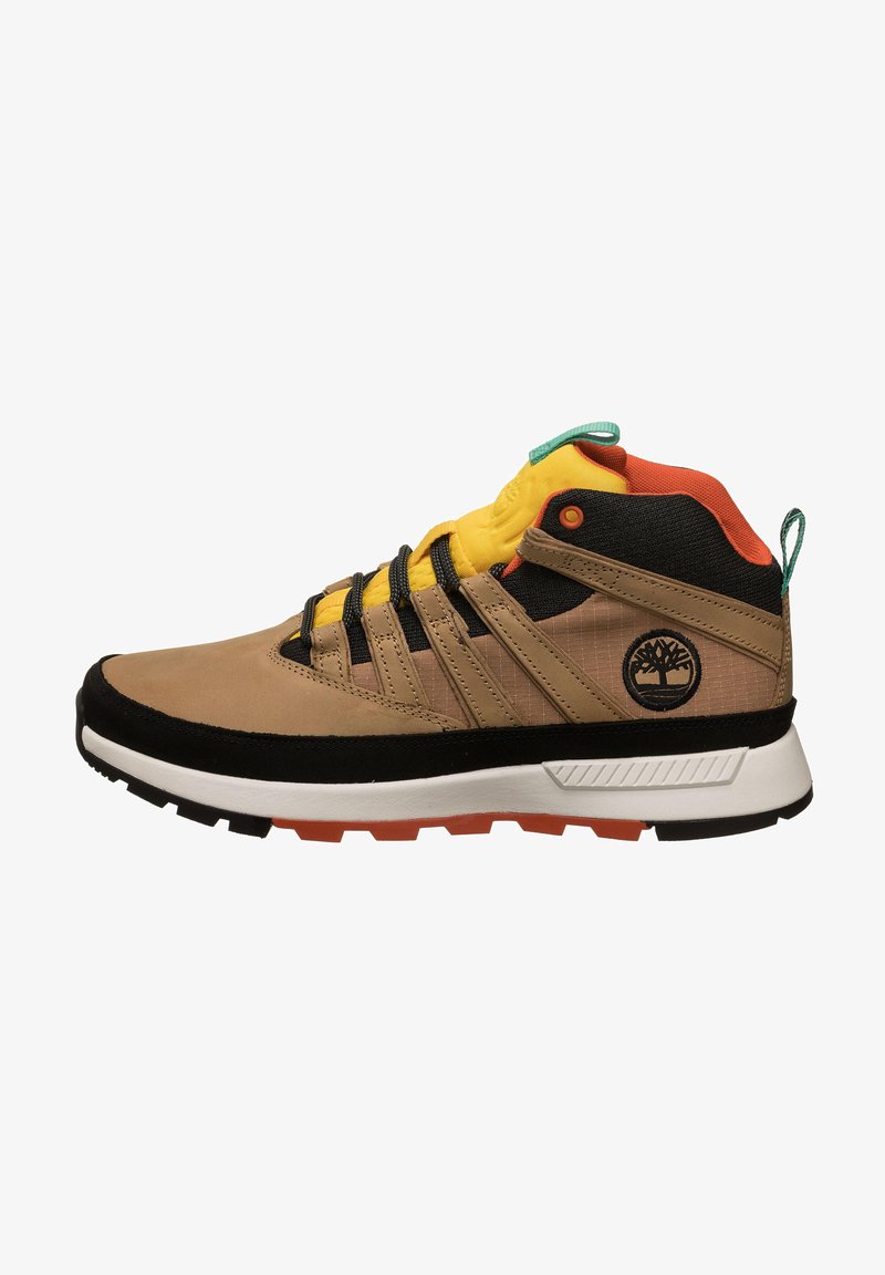 Mid-cut hiking shoes in tan and black, featuring yellow accents, a textured surface, lacing system, and a rubber sole with orange elements.