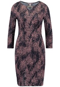 Robe à manches longues avec un fond bleu marine orné d'un motif de petits points roses, un col arrondi et une silhouette ajustée. Texture de tissu lisse.