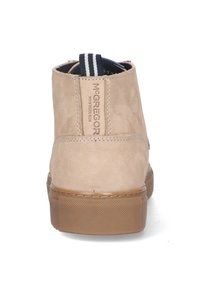 Beige suede ankle boot with a textured finish, rubber sole, and striped fabric pull tab. Branding visible on the back.