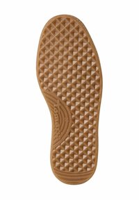 Rubber shoe sole in light brown, featuring a textured pattern of raised diamonds and ribbed accents near the heel. Brand logo visible.