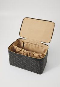 Gray patterned cosmetic bag with a gold zipper and beige interior lining. Features an inner zip pocket and gathered storage compartment.