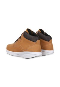 Botas altas de cuero marrón con suelas blancas, que cuentan con un cuello negro texturizado y cordones oscuros, diseñadas para el uso informal.