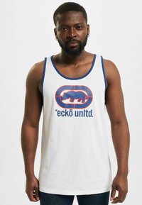 Witte mouwloze tanktop met blauwe accenten. Voorzien van een groot rood en blauw graphic logo van een neushoorn en de tekst "*eckö unltd." aan de voorkant.