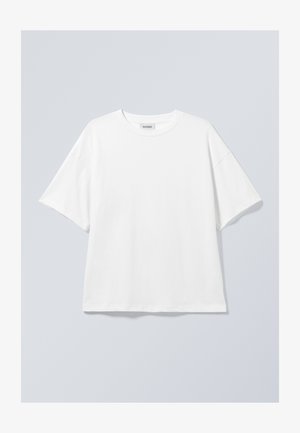 T-shirt en coton blanc avec un col rond et des manches courtes. Coupe décontractée sans motifs ni accents visibles. Texture lisse.