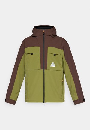 Green and brown jacket with a zip front, hood, two chest pockets, and triangle logo. Features contrasting colors and a soft texture.
