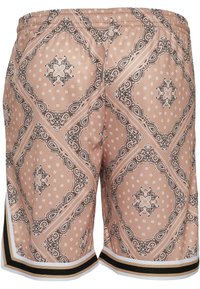Lys rosa shorts med svart paisley-mønster, med et diamantdesign. Elastisk midjebånd, kontrasterende svart og hvitt strippet trim ved kanten.