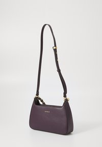 Purple leather handbag with textured surface, gold hardware accents, adjustable strap, and a slim, angled silhouette.