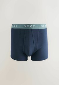 Boxer in cotone blu navy con elastico in vita di colore verde chiaro con la scritta "NEXT" stampata in bianco. Tessuto morbido e design aderente.
