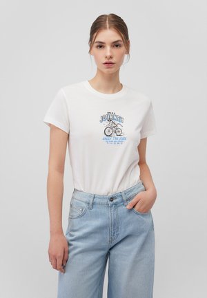 White cotton t-shirt with short sleeves featuring a blue graphic print of a bicycle and text. Paired with light blue wide-leg jeans.