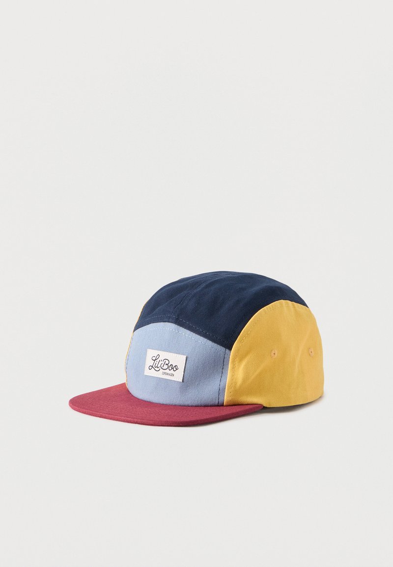Casquette multicolore avec des panneaux bleu marine, bleu clair, jaune et une visière rouge, portant une étiquette "Lil Boo" sur le panneau central avant.