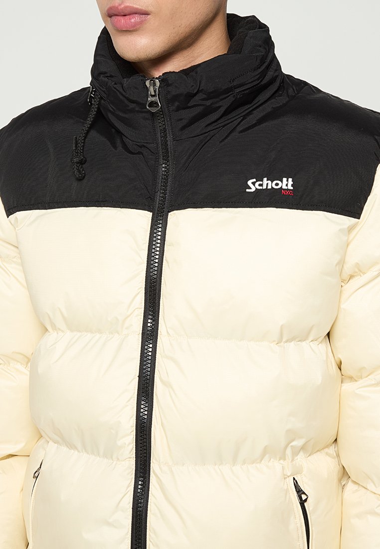 Puffjacke, schwarzer oberer Teil, cremefarbener unterer Teil, mit Reißverschluss, auf der Brust mit einem Logo und einer Kordelzugkapuze.