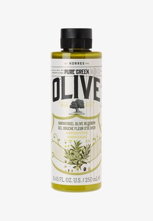 Transparent bottle with a green tint, featuring black and white text. Label highlights "Showergel Olive Blossom" and botanical illustrations.