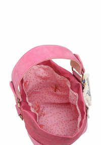Borsa a tracolla in tessuto rosa con una larga cinghia, interno foderato con pois e una tasca con zip. All'interno è presente il marchio "Frida Kahlo".