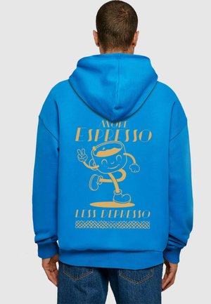Blue hoodie with a large graphic on the back featuring a cartoon character, text "More Espresso, Less Depresso" in gold, and a patterned border.