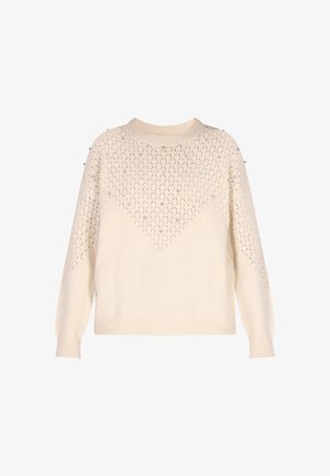 Kreemivärvi kudum, millel on rombikujuline muster ja peened kaunistused. Ümmargune kaelus, pikad varrukad ja ribastatud serv.