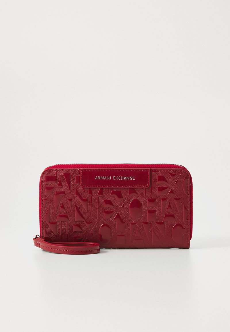 Red leather wallet featuring an embossed logo design. It has a zip closure, a detachable wrist strap, and a glossy finish.