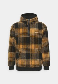 Pull polaire à motif à carreaux jaune et noir avec col mi-zip et poignets élastiques. Comprend une poche avant et un tissu texturé.