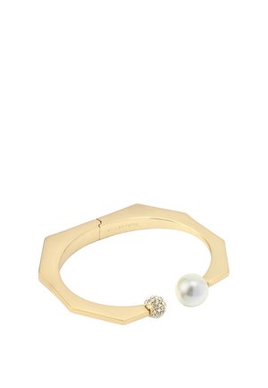 Gold octagonal bangle featuring a pearl and a crystal-embedded orb. Smooth texture with a polished finish.