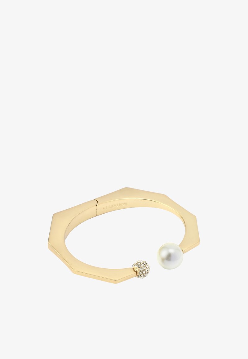 Kultainen oktaagonalirannekoru, jossa on helmi ja kristallilla päällystetty pallo. Sujuva pinta ja kiillotettu viimeistely.