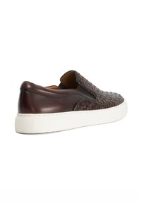 Brown leather slip-on shoes with woven texture, white rubber sole, and elastic side accents for easy wear. Smooth back panel and rounded toe.