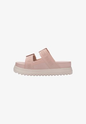 Pink slide sandals featuring wide straps with embossed branding, a rounded sole, and a textured outsole for improved grip.