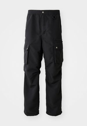 Black cargo pants with elastic waistband, multiple side pockets, and a smooth, durable fabric. Features silver accent hardware.