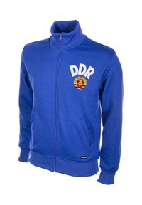Blauwe zip-up sweatshirt met hoge kraag. Voorzien van "DDR" in witte tekst en een ronde embleem. Het materiaal is zacht met ribgebreide boorden en onderkant.