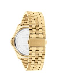 Goldfarbener Edelstahlarmbanduhr mit einem Gliederarmband, achteckigem Gehäuse und einem klaren Ziffernblatt, das "TOMMY HILFIGER" und minimalen Text anzeigt.
