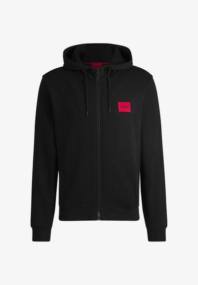 Sweat à capuche noir zippé avec cordon de serrage et patch rectangulaire rouge avec logo HUGO sur la poitrine gauche.