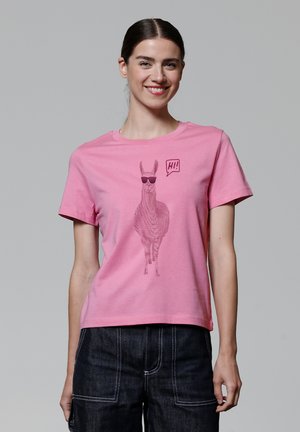 T-shirt en coton rose avec un graphique de lama portant des lunettes de soleil et une bulle de dialogue avec "Salut !" imprimé sur le devant, manches courtes.