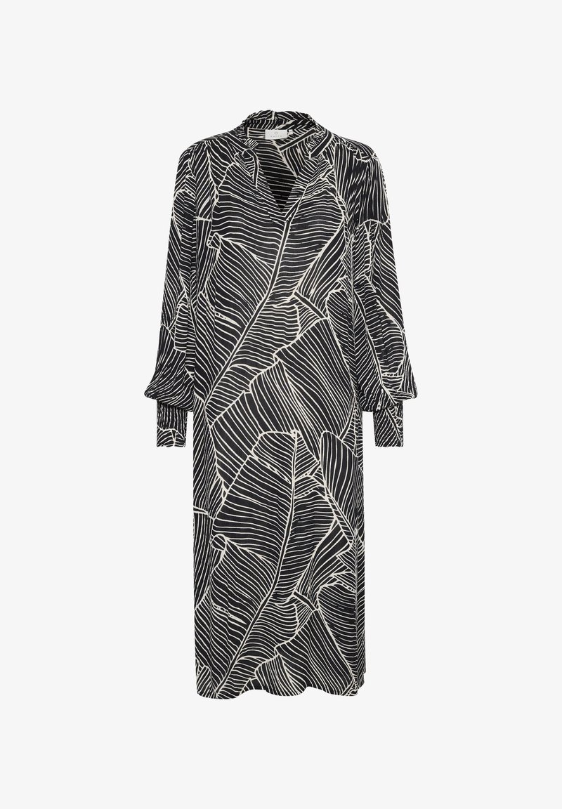 Melna kleita ar baltām lapu rakstiem, garām piedurknēm ar aprocēm, augstu apkakli un brīvu piegriezumu. Audumam ir gluda tekstūra.