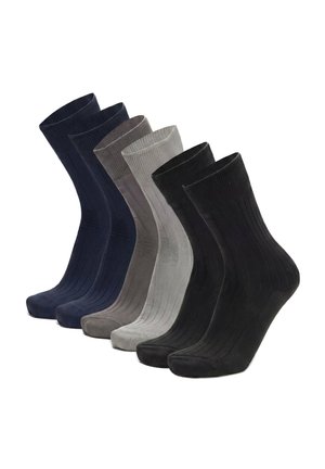 Sei paia di calzini a coste neri, grigio scuro, grigio chiaro e blu navy disposti uno accanto all'altro.