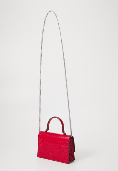 Red faux-crocodile leather handbag with a structured design, featuring a top handle and a silver chain strap. Textured surface with accents.