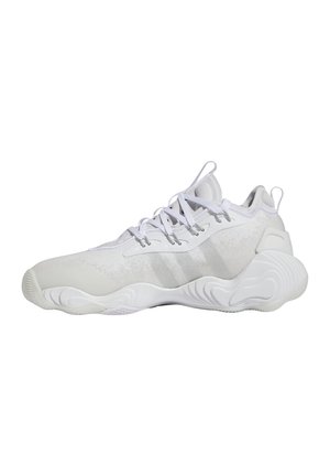 Des chaussures de sport blanches avec un tissu lisse et une semelle en caoutchouc, présentant de subtils accents gris, une tige texturée et un système de laçage traditionnel.