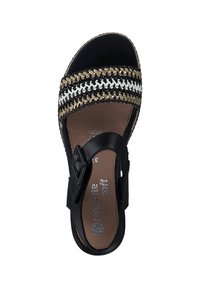 Black sandal with a woven strap featuring gold and white accents. Leather upper, flat sole, and adjustable buckle for fit.