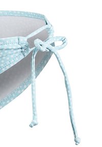 Haut de bikini bleu clair avec des pois blancs, doté de liens ajustables et d'une finition texturée le long des bords et des bretelles.