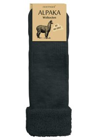 Schwarze Socken aus Alpaka-Wolle mit einem strukturierten Strickdesign und einem plüschigen, flauschigen Bund für zusätzlichen Komfort und Wärme. Verpackung des Produkts inklusive.